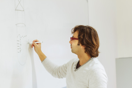 Teacher writing on blackboard graphicsの写真素材