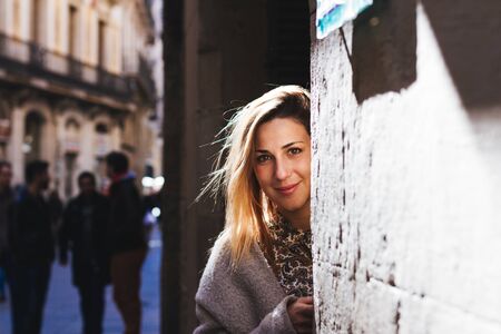 Portrait of woman in the street with the sun on his backの写真素材