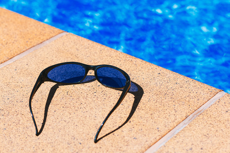 Blue sunglasses in the poolの写真素材