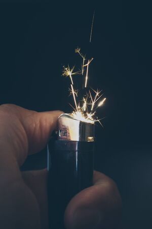 Hand with lighter igniting sparksの写真素材