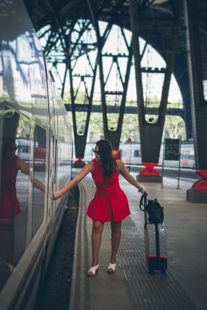 Red woman taking the trainの写真素材