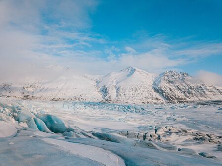 Beautiful glaciers flow through the mountains in Iceland. Aerial view and top view.の写真素材