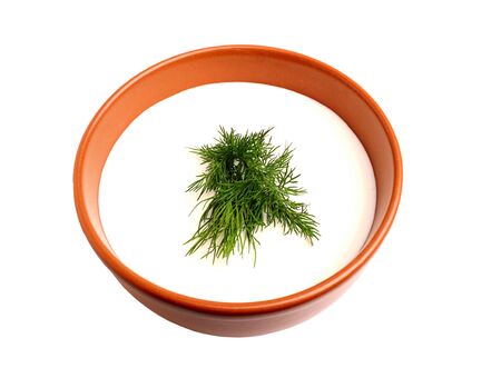 Sour cream and dill in a bowl. isolated on white backgroundの写真素材