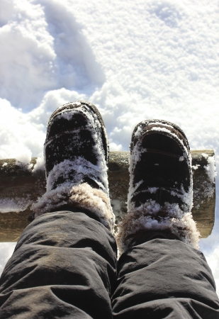 Feet in boots in the snow の写真素材