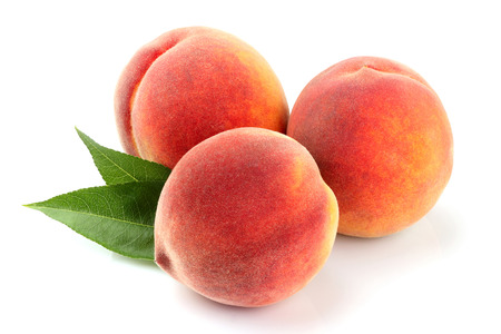 Peach fruits with leaf isolated on white background.の写真素材