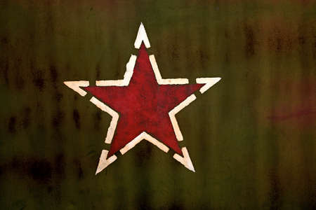 Red star symbol printed on dark green backgroundの写真素材