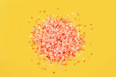 Pink salt crystals on bright yellowの写真素材