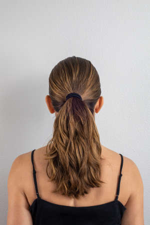 Woman back with hair in ponytailの写真素材
