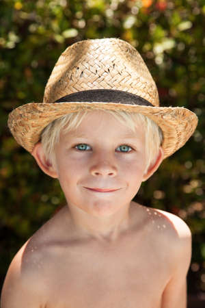 Blonde boy in straw hatの写真素材