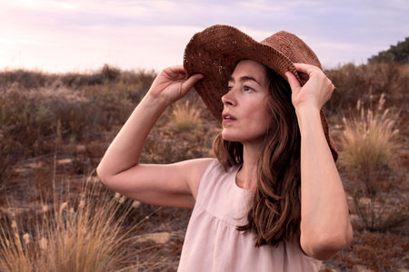 Woman in pink dress and a hatの写真素材