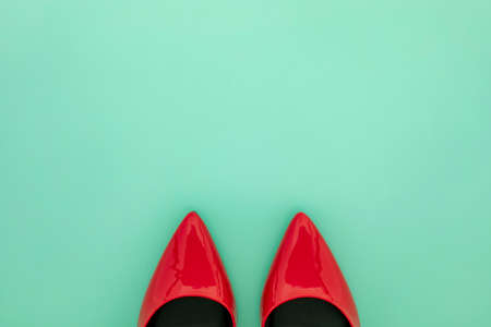 Red women shoes on mint green backgroundの写真素材