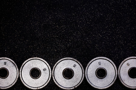 Weight plates in line on the floor