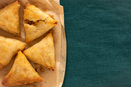 Samosas on the paper with linen closeupの写真素材