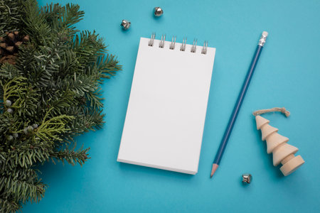 Blank notepad with Christmas decor on blue