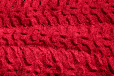 Truck tire imprint on viva magenta sandの写真素材