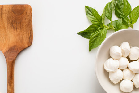 Mozzarella, basil and wooden spatulaの写真素材