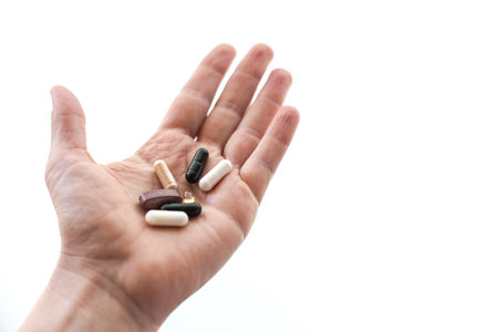 Open hand with daily supplement pillsの写真素材