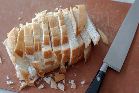 Sliced white sourdough bread loaf and knife