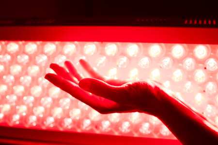 Hand and LED red light therapy lampの写真素材
