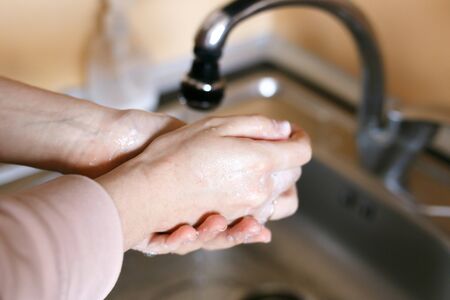 Corona virus travel prevention wash hands with soap and hot water. Hand hygiene for coronavirus outbreak. Protection by washing hands frequently.の写真素材