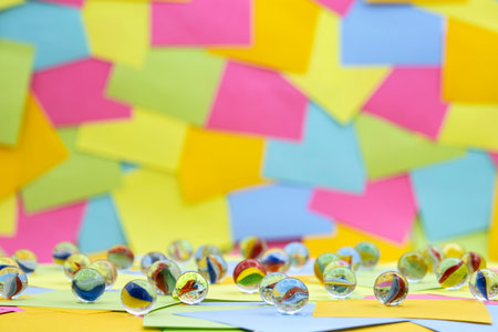 decorative glass balls on a background of multicolored paper sticky notesの写真素材