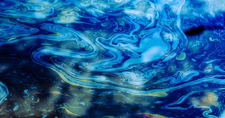 Rainbow colors created by diesel fuel floating on the water