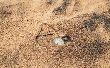 Sands of time, Antique rotten pocket watch buried partial in the sand.