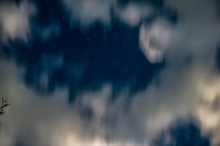 night sky with stars and clouds, motion blurの写真素材