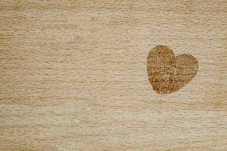 wooden board with a heart engraved on itの写真素材