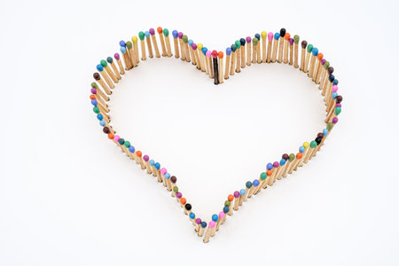 a heart shape made of multicolored matchsticksの写真素材