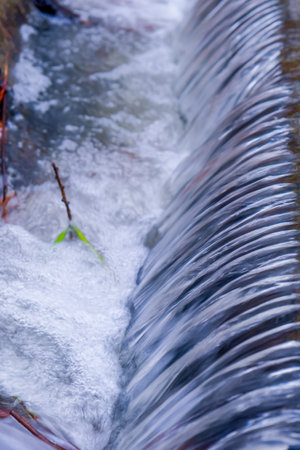 a small waterfall on the riverの写真素材