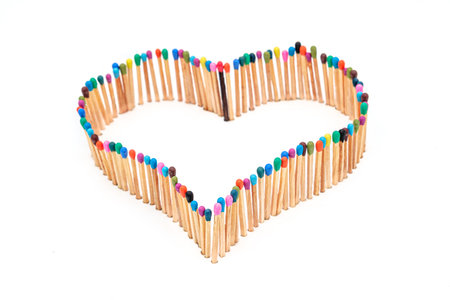 a heart shape made of multicolored matchsticksの写真素材