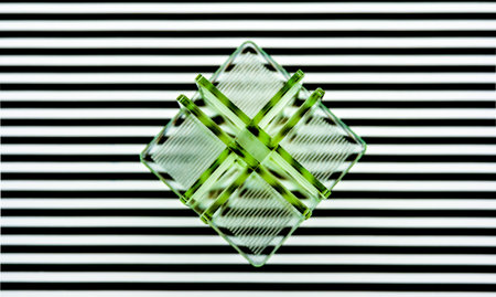 abstract green plastic shape on white stripesの写真素材