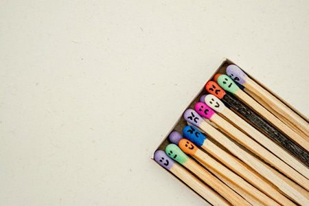 Box with Multicolored matchsticks with faces painted on the headsの写真素材