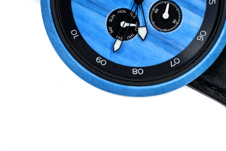 blue wood watch with leather strap on white backgroundの写真素材