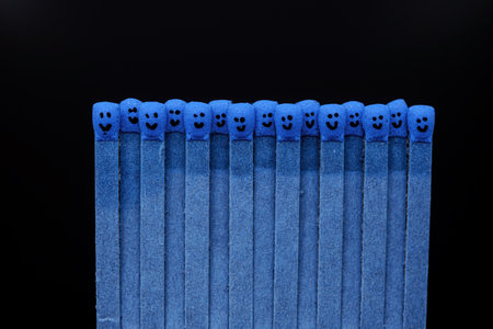 blue matchsticks with faces painted on the headsの写真素材