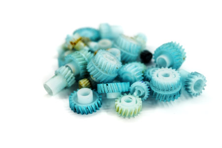 Dirty plastic gears on white backgroundの写真素材