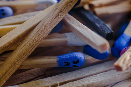 Macro view of the Multicolored matchsticks with faces painted on the headsの写真素材