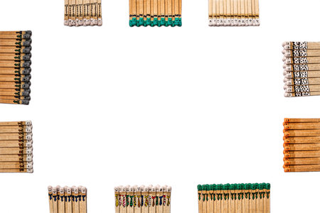frame made of matchsticks with faces painted on the heads on white on whiteの写真素材