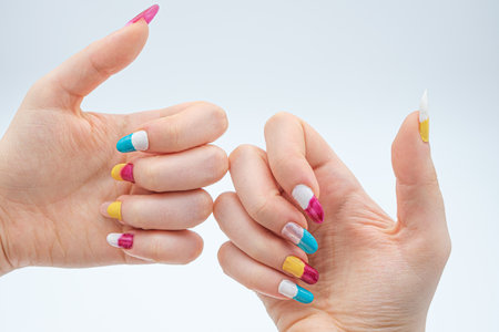 girls hand with Two-tone manicure on white backgroundの写真素材