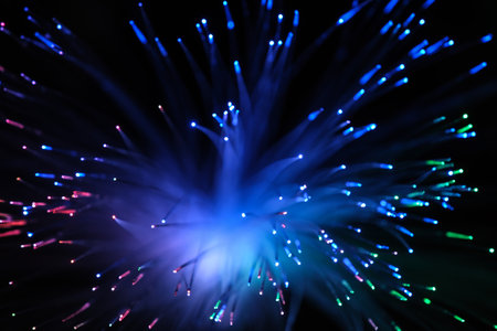 Optical fiber network cable on black background.
