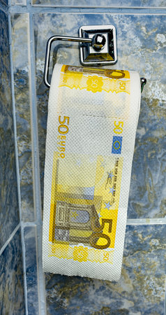 Roll of Euro bank notes toilet paper in bathroomの写真素材