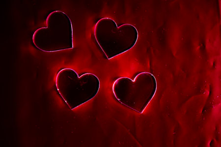 plastic hearts shape on red background