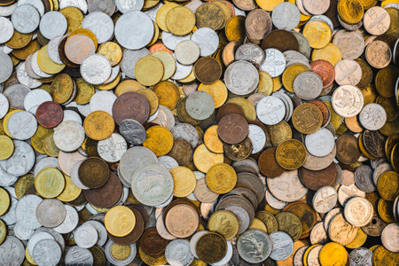 pile of coins from different countriesの写真素材