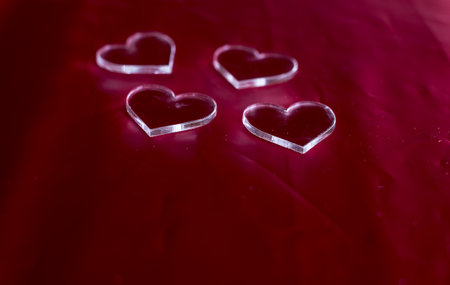 plastic hearts shape on red background