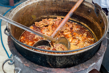 Romanian traditional food prepared at the cauldron on the open fireの写真素材