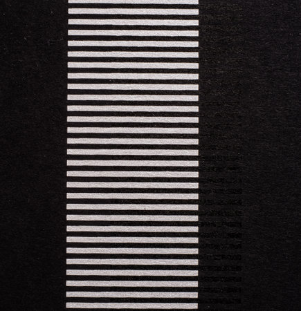 A dense industrial sheet of grey paper with a textured surface and geometric shapesの写真素材