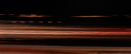 Abstract defocused light trails on the dark background, motion blurの写真素材