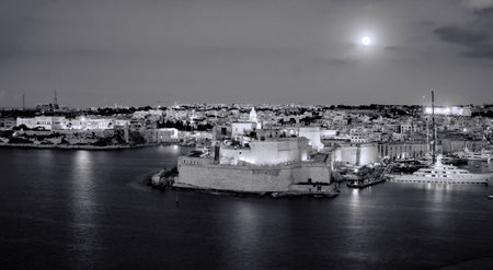 Restored medieval Fort St. Angelo on a peninsula with scenic Grand Harbour views & historical displays at blue hours in Maltaの写真素材