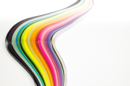 Abstract color wave curl rainbow strip paper on white backgroundの写真素材